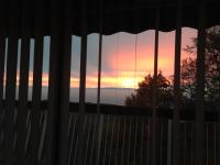 a sunset seen through a window with a fence at Petit moment de Bonheur in Turckheim