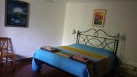 A bed or beds in a room at Il Giardino dei Merli
