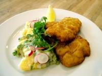 Un plato de comida con pollo y patatas y una ensalada. en ProFamily Hotel TOP Benecko, en Benecko