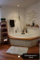 a bathroom with a bath tub with a shower at Haus Berger in Fuschl am See