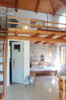 a bedroom with a bed in a room with wooden ceilings at Kastraki Art Houses in Kousounárion