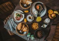 a table with plates of food on top of it at Hôtel Les Grangettes in Méribel