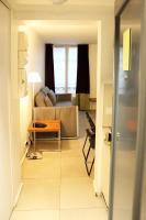 a living room with a couch and a table at MULTIRESIDENCE L&#39;ELYSEE Paris in Paris