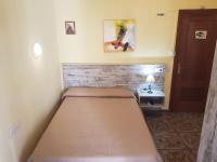 A bed or beds in a room at Hostal Virgen Del Rocío
