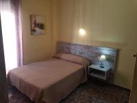 A bed or beds in a room at Hostal Virgen Del Rocío