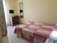 A bed or beds in a room at Hostal Virgen Del Rocío