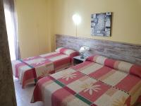 A bed or beds in a room at Hostal Virgen Del Rocío