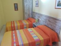 A bed or beds in a room at Hostal Virgen Del Rocío
