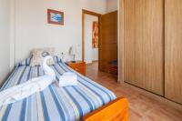 A bed or beds in a room at Holiday Apartment Casa Vista Mar Oliastur El Cotillo