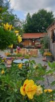 a garden with yellow flowers in front of a house at Chrom Ranch Reiterhof in Memmingen