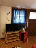 a living room with a tv and a table and a window at Chrom Ranch Reiterhof in Memmingen