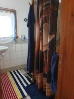 a bathroom with a shower curtain and a sink at Chrom Ranch Reiterhof in Memmingen