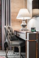 a room with a desk with a chair and a lamp at Aries Hotel & SPA Wisła in Wisła