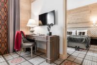 a bedroom with a bed and a desk with a computer at Aries Hotel & SPA Wisła in Wisła