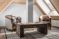 a living room with two chairs and a table at Aries Hotel & SPA Wisła in Wisła