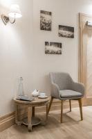 a living room with a chair and a table at Aries Hotel & SPA Wisła in Wisła