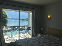 a bedroom with a balcony with a view of the water at RESIDENCE DU PORT in Le Bourget-du-Lac