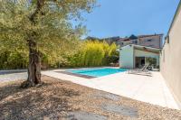 a swimming pool with a tree next to a house at Othil in Aire-sur-lʼAdour