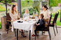 利沃夫Citadel Inn Gastro Boutique Hotel - Готель Цитадель Львів的坐在餐厅桌子旁的家庭