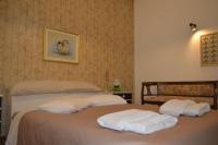 A bed or beds in a room at Triple H