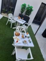 a table with plates of food on top of grass at Hôtel Emilie in Royan