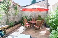 a table and chairs with an umbrella on a patio at Demeure Belle Epoque in Reims