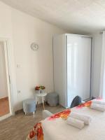 a bedroom with a bed and a clock on the wall at Apartment Beach in Makarska