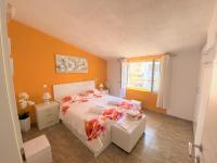 a bedroom with a bed with orange walls and a window at Apartment Beach in Makarska