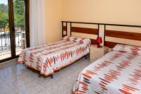 Postel nebo postele na pokoji v ubytování Hostal El Trillero