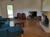 a living room with a couch and a fireplace at mas cantarello in Rognes