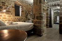 a bedroom with a bed in a brick wall at Chambre Comballe charmante avec jacuzzi in Sanilhac