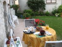 a table with a plate of food on it at Murmure des buis in Corveissiat