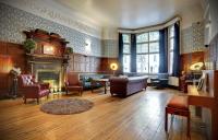 a living room filled with furniture and a fireplace at Astor Hyde Park Hostel in London