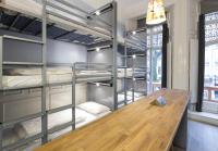 a room with bunk beds and a wooden table at Astor Hyde Park Hostel in London