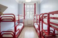 a room with four bunk beds in it with a window at Astor Hyde Park Hostel in London