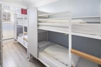 a room with white bunk beds in it at Astor Hyde Park Hostel in London