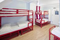 a room with three bunk beds and a hallway at Astor Hyde Park Hostel in London