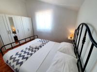 Posteľ alebo postele v izbe v ubytovaní Apartmani Mikulić