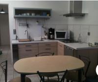 a kitchen with a table and a table and chairs at Appartement sympa Arcachon in Arcachon
