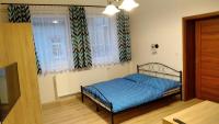 Postel nebo postele na pokoji v ubytování Apartmány Kukaččí hnízdo