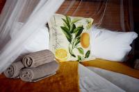 a pile of towels and a pillow on a bed at Addo Dung Beetle Guest Farm in Addo