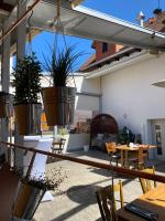 a patio with potted plants on a building at Hotel-Gasthaus-Kraft in Schauenburg