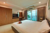 Postel nebo postele na pokoji v ubytování Nalanta Hotel Pattaya