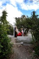 a red chair sitting on a set of concrete stairs at Addo Dung Beetle Guest Farm in Addo