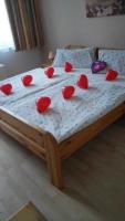 a bed with red hearts on top of it at Südtiroler Stubn Café und Restaurant in Arnstadt