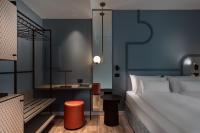 A bed or beds in a room at HT Hotel Trieste