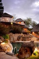 a home with a swimming pool and a house at Addo Dung Beetle Guest Farm in Addo