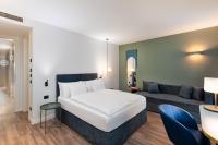 A bed or beds in a room at HT Hotel Trieste