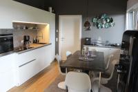 a kitchen and dining room with a table and chairs at Penthouse Skyview im Natur-Erlebnispark Bad Kleinkirchheim in Patergassen