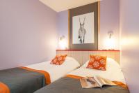 two beds in a room with a picture of a deer on the wall at Résidence Pierre &amp; Vacances Electra in Avoriaz